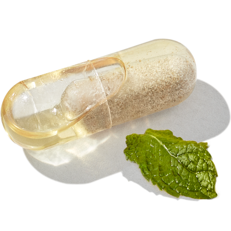 Close-up image of Essential Postnatal capsule with mint leaf
